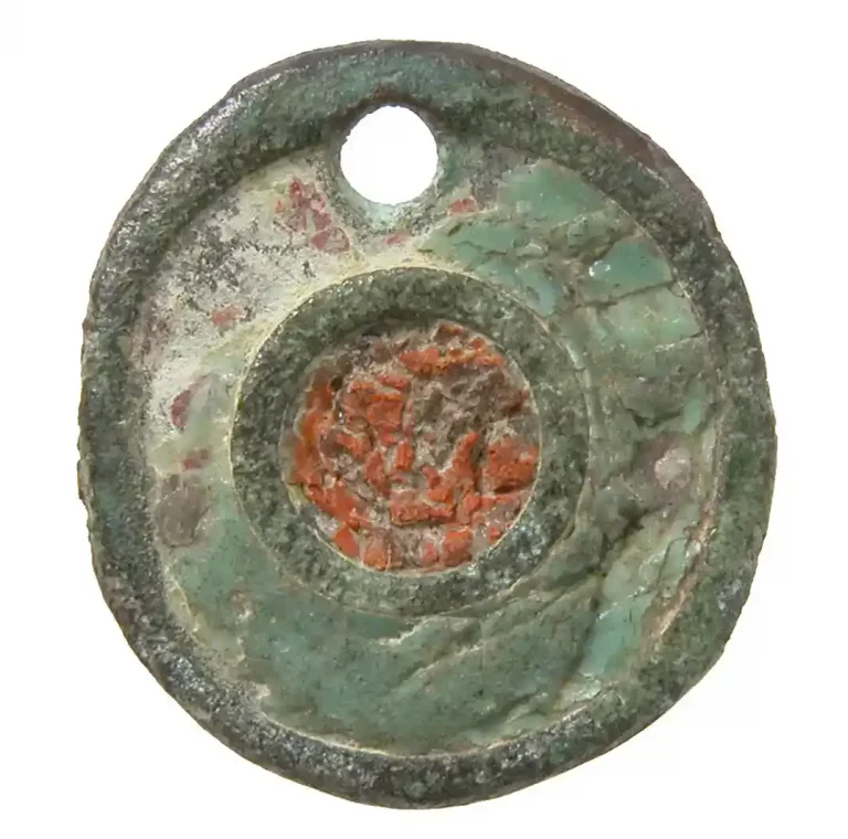 Ancient Roman flat circular button; copper alloy with enamel; 100–300 CE