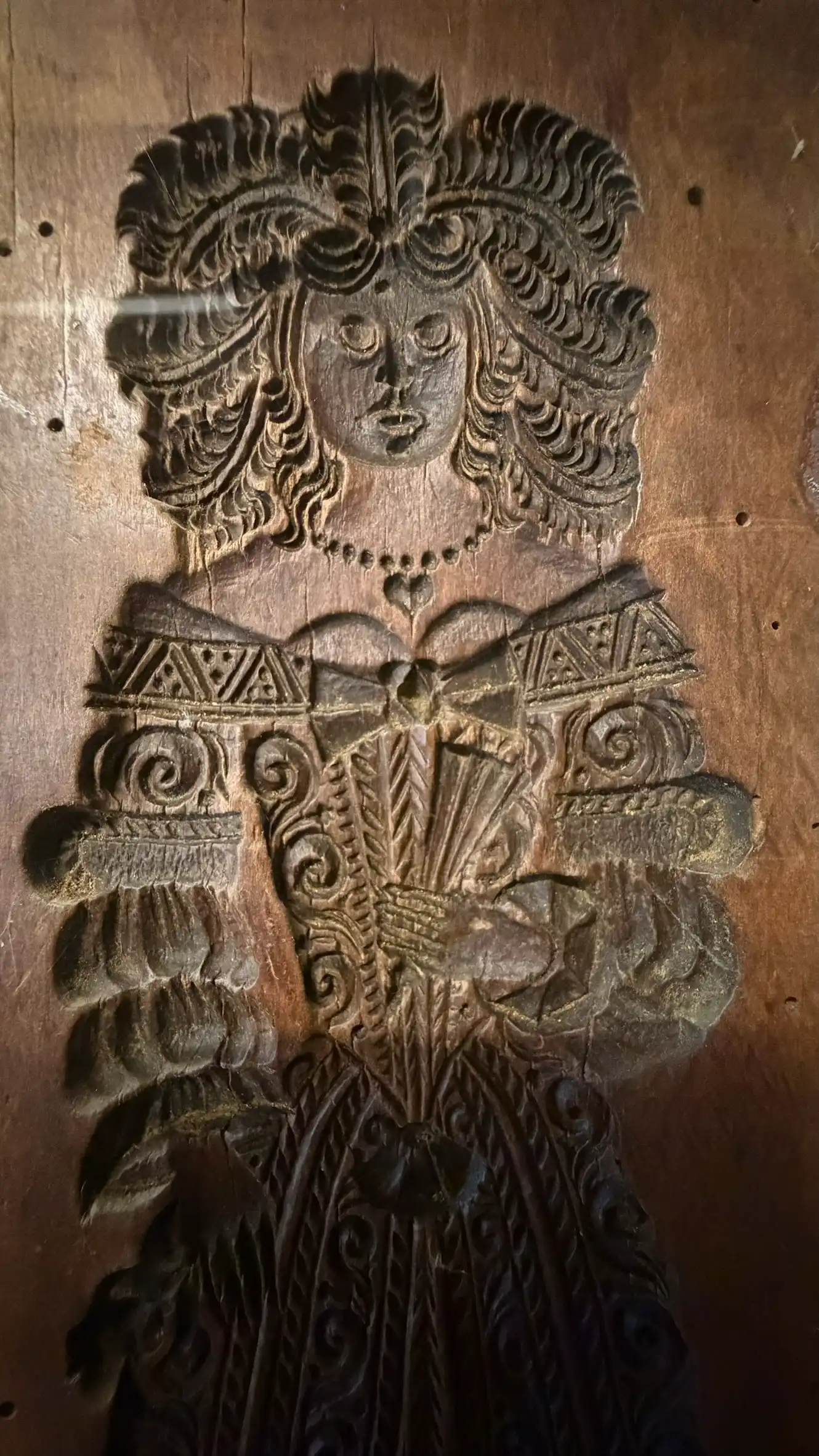 Wooden mould with carved standing female figure motif