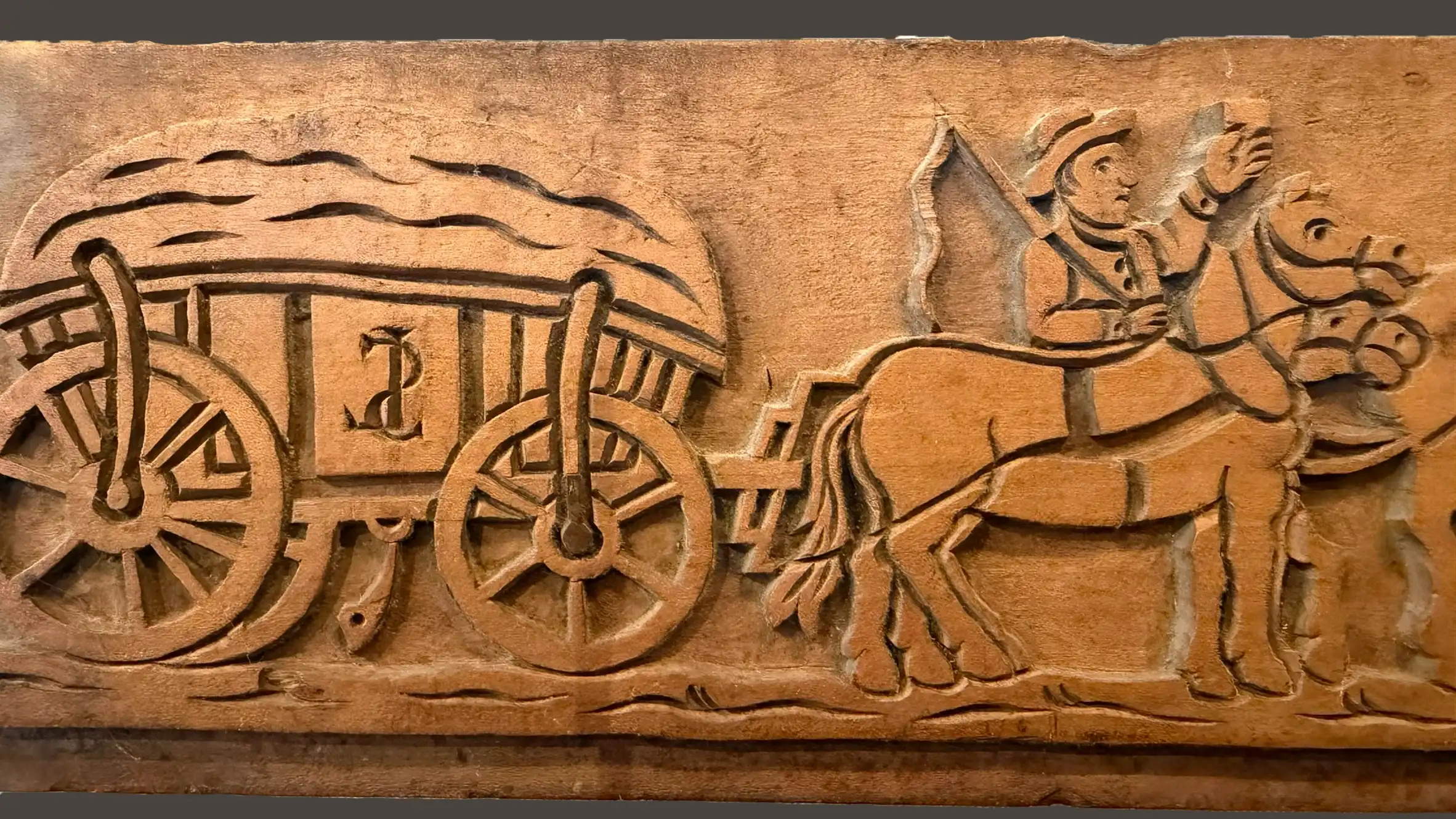 Wooden mould with carved horse-drawn cart motif