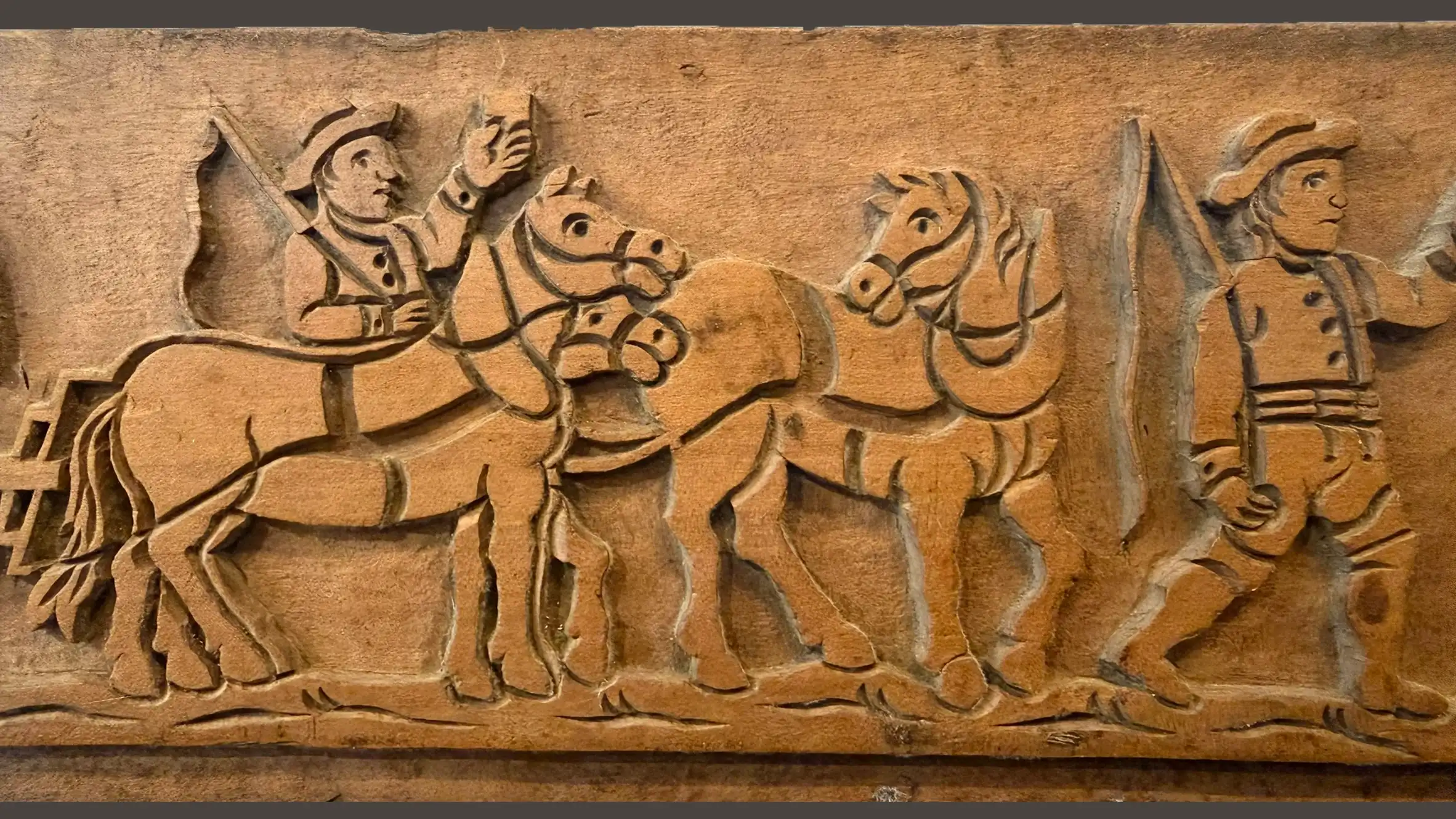 Wooden mould with carved horse and rider procession motif