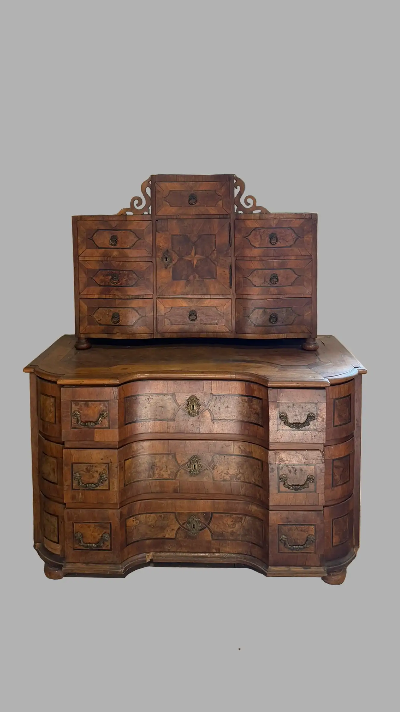 Mid-18th-century Baroque tabernacle cabinet with bombé commode base, marquetry veneers, and brass mounts.